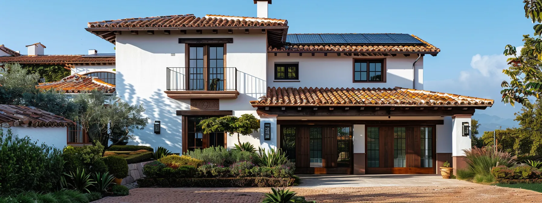 a spanish style house with rustic charm features sleek solar panels on its clay-tiled roof, seamlessly combining traditional design with modern energy-efficient amenities.