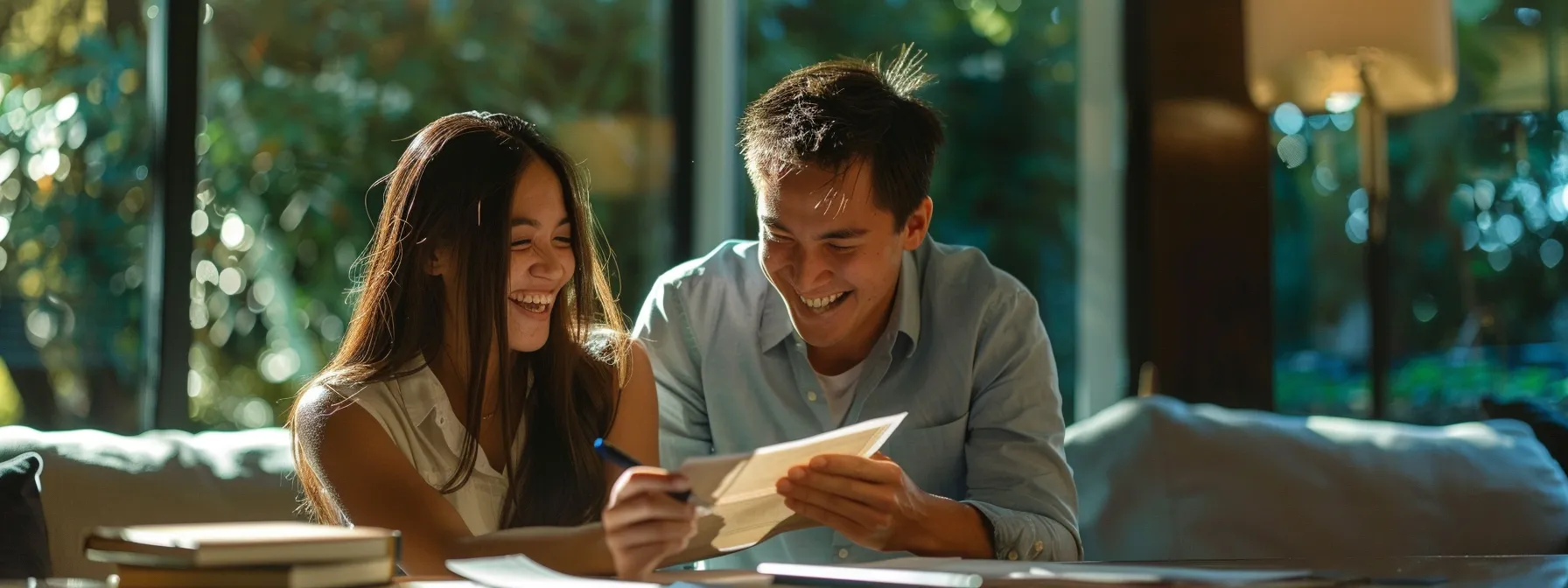 a young couple excitedly signing a real estate contract together, highlighting the legal age requirements for buying a house.