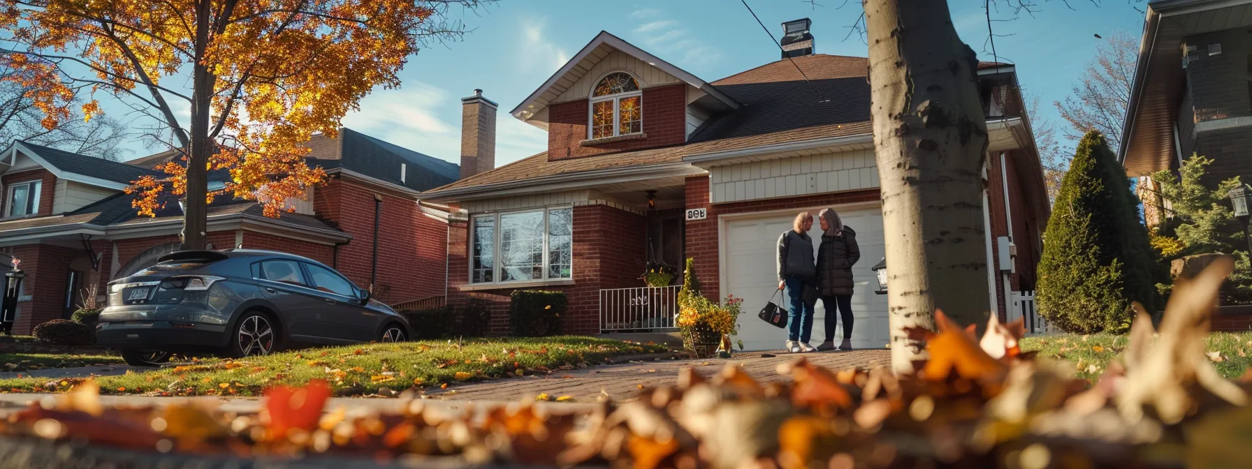 a couple standing in front of a charming suburban house, calculating mortgage payments and down payments on a sunny day.